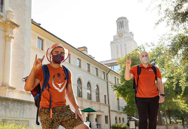 UT Students wearing masks in front of Tower